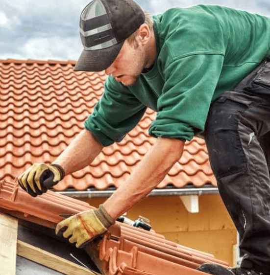 Professional roofer working on roof installation