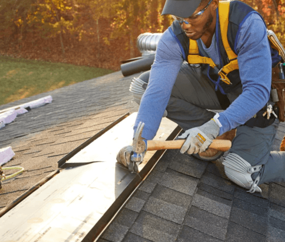Professional roofer working on roof installation